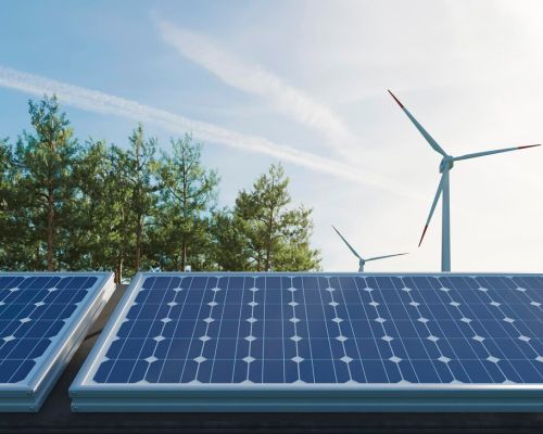 Solar panels and wind turbines illustrating renewable energy for CO₂ reduction.